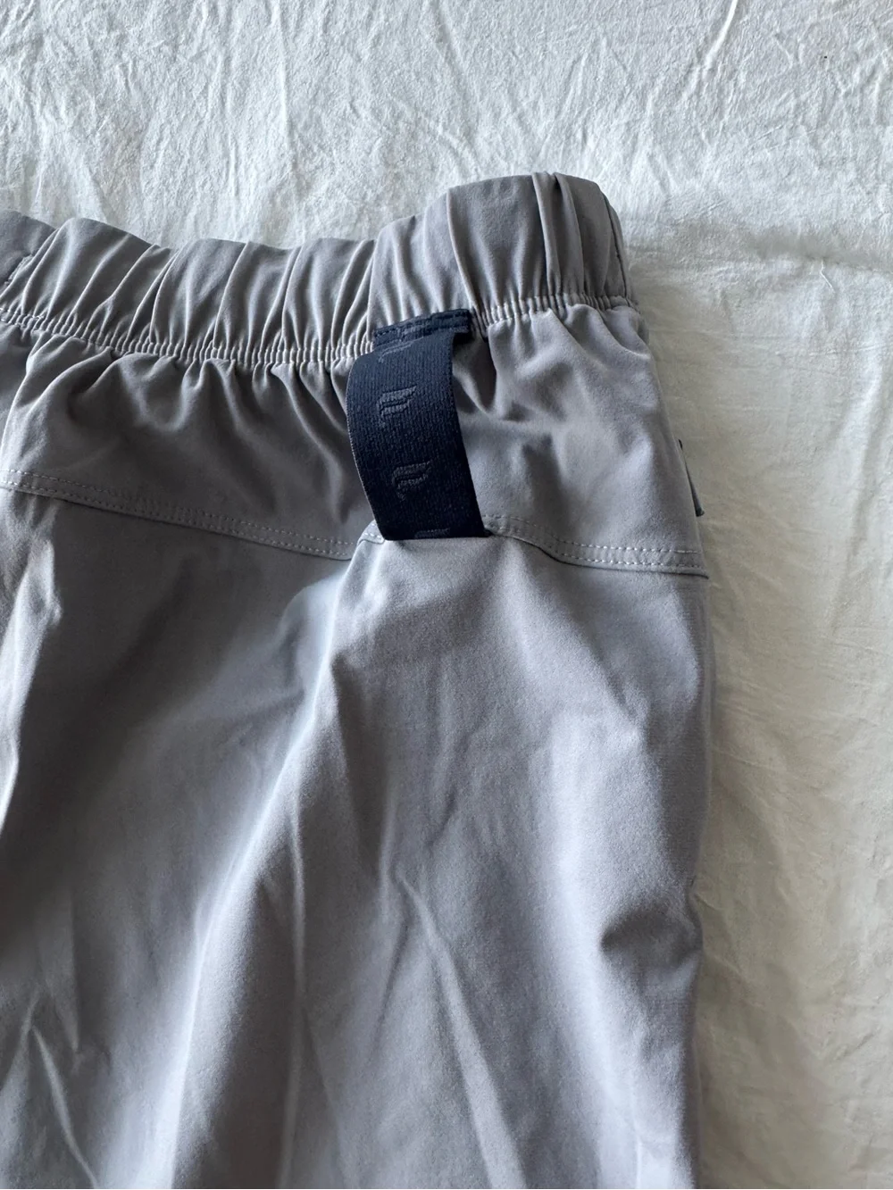 Fabletics Men's Light Gray Athletic Shorts with Navy Drawstring